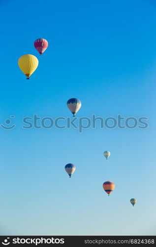 Colorful hot air balloons flying over the valley at Cappadocia