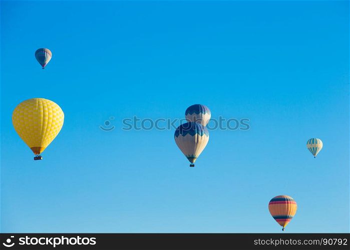 Colorful hot air balloons flying over the valley at Cappadocia