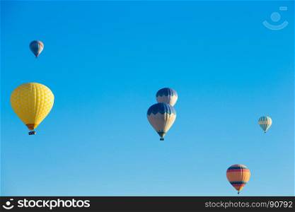Colorful hot air balloons flying over the valley at Cappadocia