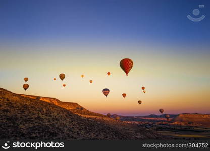 Colorful hot air balloons flying over the valley at Cappadocia,Anatolia,Turkey.NEVSEHIR/TURKEY- JULY 23,2016. Colorful hot air balloons flying over the valley at Cappadocia,Anatolia,Turkey.The great tourist attraction of Cappadocia best places to fly with hot air balloons.NEVSEHIR/TURKEY- JULY 23,2016
