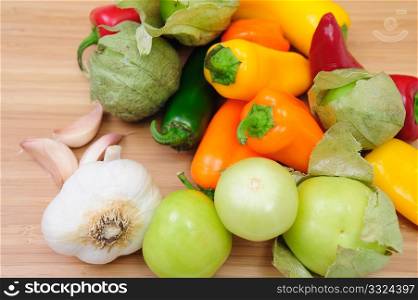 Colorful Hot and Sweet Peppers with Tomatillos and garlics cloves. Hot And Sweet Peppers