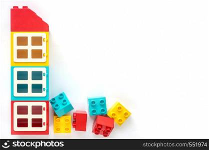 Colorful House of Small and big plastic constructor bricks on white background. Popular toys.. House of Small and big plastic constructor bricks on white background. Popular toys.