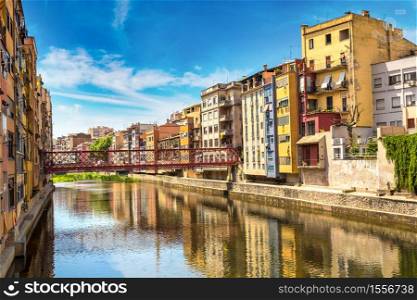 Colorful houses and Eiffel bridge in Girona, in a beautiful summer day, Catalonia, Spain