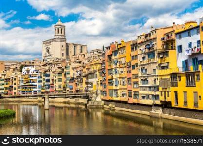 Colorful houses and Saint Mary Cathedral at background in Girona, in a beautiful summer day, Catalonia, Spain