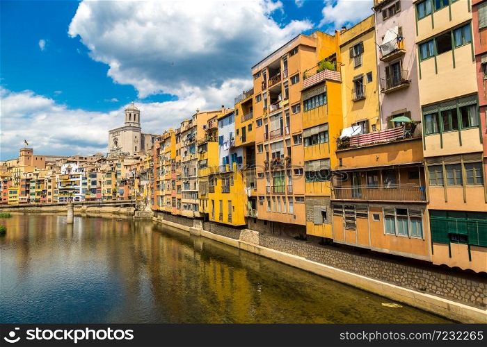 Colorful houses and Saint Mary Cathedral at background in Girona, in a beautiful summer day, Catalonia, Spain