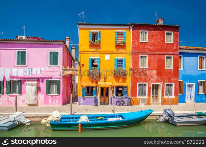 Colorful houses in downtown Burano, Venice, Italy with clear blue sky