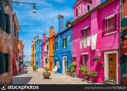 Colorful houses in downtown Burano, Venice, Italy with clear blue sky