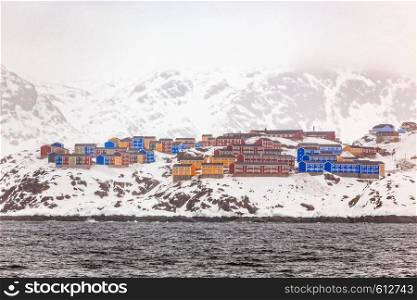 Colorful houses of Sisimiut, on the rocks and snow, Greenland