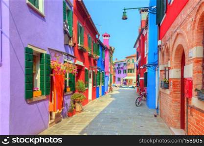 Colorful houses on Burano island, near Venice, Italy. Charming street. Sunny day.