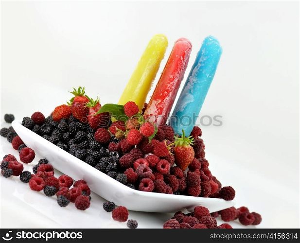 colorful ice cream pops with fresh raspberries and blackberries