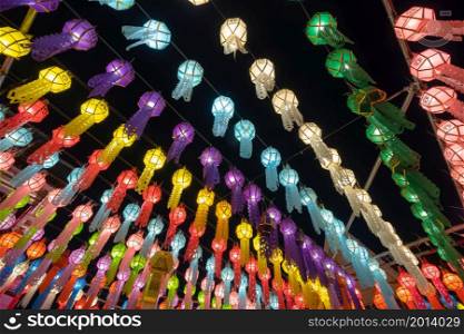 Colorful illuminated lanterns or lamps at night in travel trip and holidays vacation concept. Traditional festival in Harikulchai Temple, Lamphun, Thailand. Traditional ceremony in Asia. Celebration