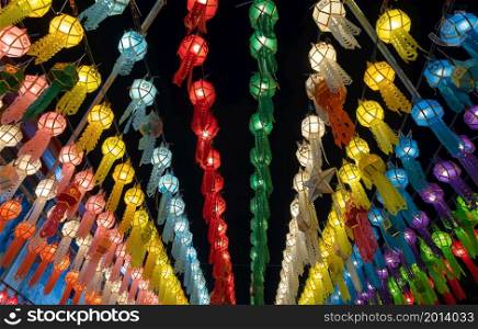 Colorful illuminated lanterns or lamps at night in travel trip and holidays vacation concept. Traditional festival in Harikulchai Temple, Lamphun, Thailand. Traditional ceremony in Asia. Celebration