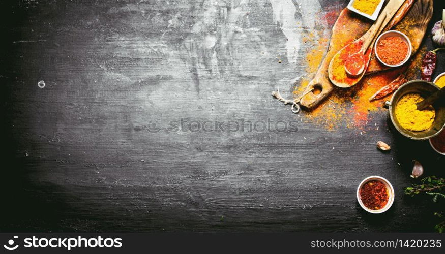 Colorful Indian spices and herbs . On the black chalkboard.. Colorful Indian spices and herbs .