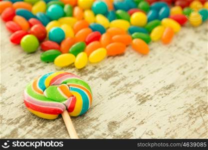 Colorful jelly beans and a round lollypop