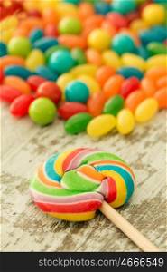 Colorful jelly beans and a round lollypop