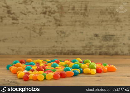 Colorful jelly beans on a wooden background