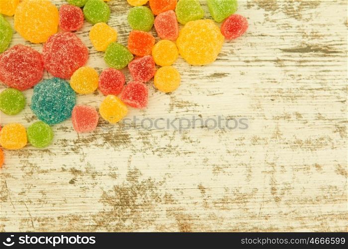 Colorful jelly beans on a wooden bakcground.