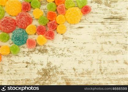 Colorful jelly beans on a wooden bakcground.