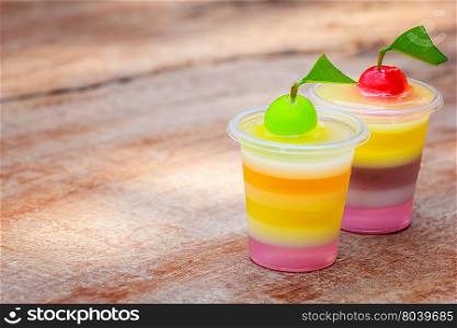Colorful jellys with fruits in plastic cups