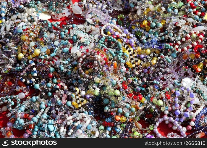 colorful jewelry necklaces mess in market pattern background
