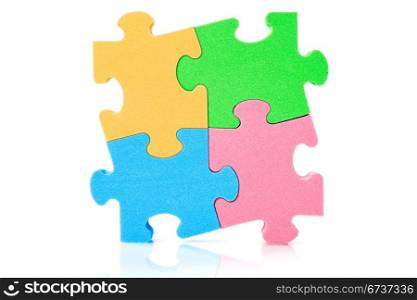 Colorful jigzaw puzzle, over a white background
