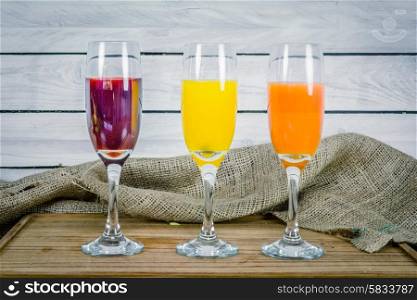 Colorful juice variations on a wooden table
