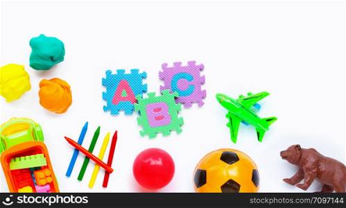 Colorful kids toys on white background. Copy space