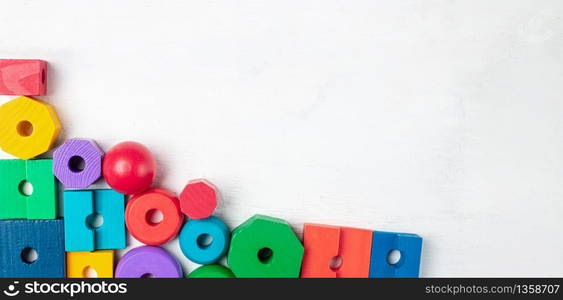 Colorful kids toys on white wooden background. Top view. Flat lay. Copy space for text