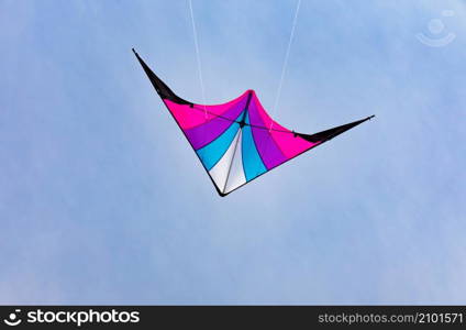 Colorful kite flying in the blue sky