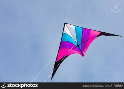 Colorful kite flying in the blue sky