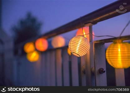 Colorful lampions outside, twilight hour, garden party