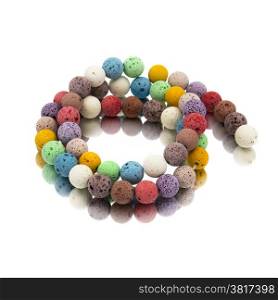 Colorful lava volcano beads with reflection. White background.