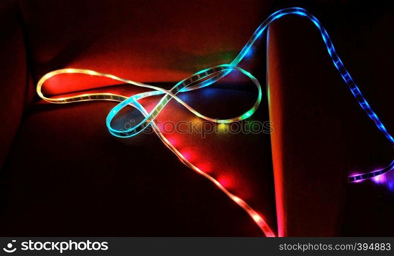 colorful led light strip on a red chair in the dark