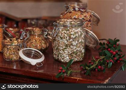 Colorful Legumes inside Glass Jars on Decorated Wooden Table: Beans, Peas and Lentils