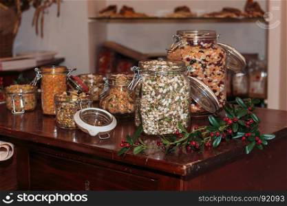 Colorful Legumes inside Glass Jars on Decorated Wooden Table: Beans, Peas and Lentils. Colorful Legumes inside Glass Jars