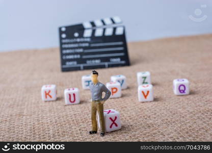 Colorful letter cubes beside a director clapper board