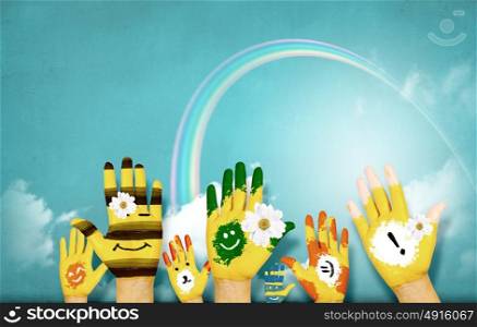 Colorful life!. Human hands in colorful paint showing symbols