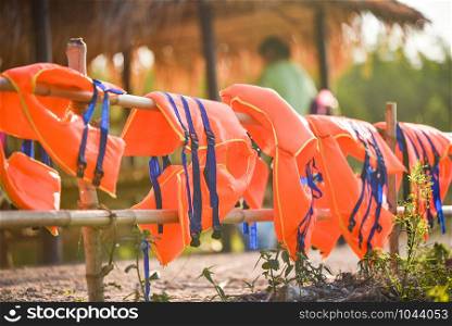 Colorful life jacket safety equipment on bamboo rail