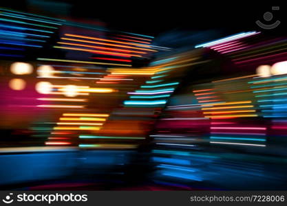 Colorful lights of urban city surrounding moving and blurred by motion. Color lights moving