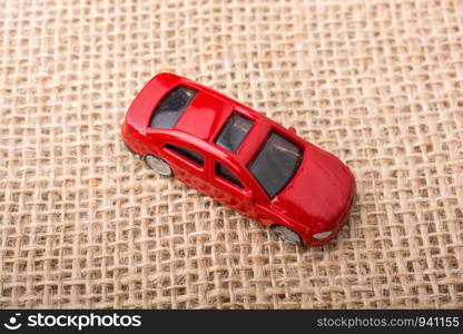 Colorful little toy car on canvas background