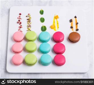 colorful Macaroni cookie French on white plate. Studio photo. sweets on a white plate