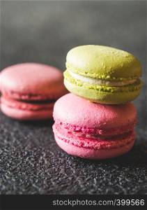 Colorful macarons on the dark background