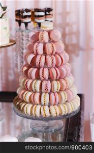 Colorful macarons stand in round transparent weight as part of candy bar sweet. Colorful macarons stand in round transparent weight as part of candy bar sweet table