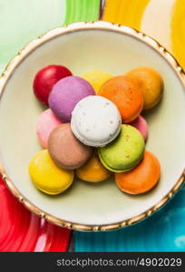 Colorful macarons various on color plate, close up, top view