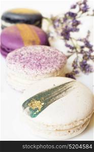 colorful macaroon cakes against white background