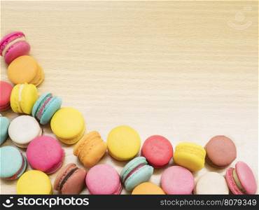 Colorful macaroon on wooden table.