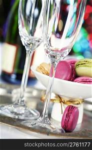 Colorful macaroons and Champagne on Christmass tree background