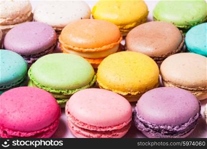 Colorful macaroons - french dessert as a background. The colorful macaroons