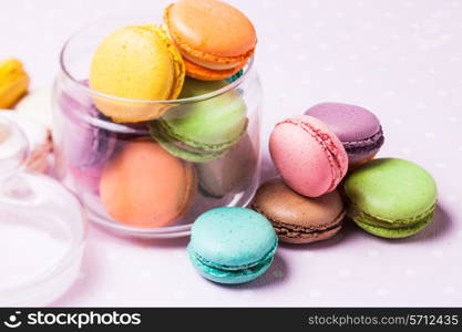 Colorful macaroons - french dessert in a glass jar