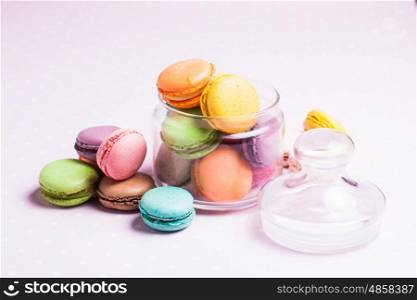 Colorful macaroons - french dessert in a glass jar. The Colorful macaroons